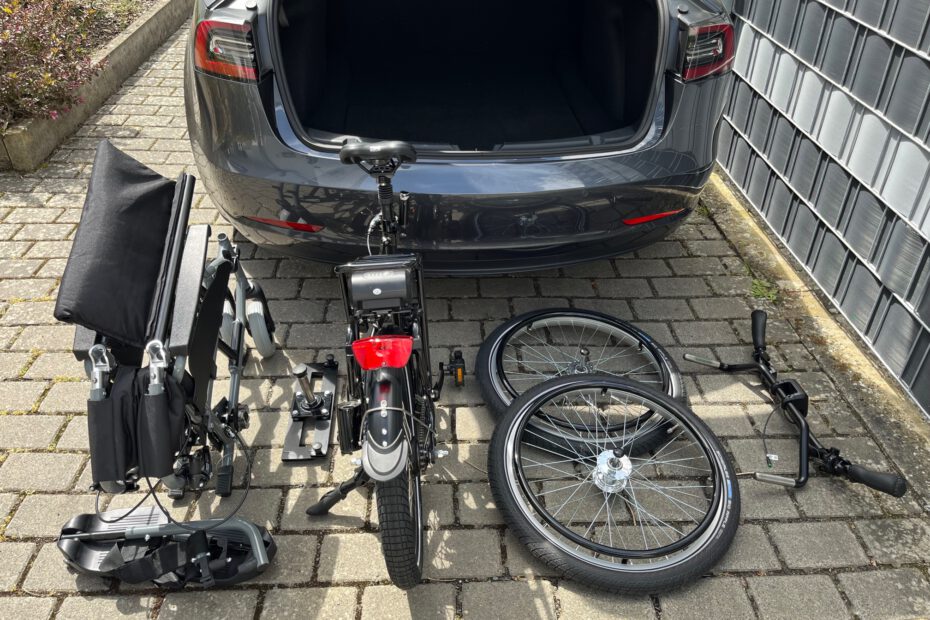 disassemled wheelchair bike ready to be loaded into the trunk